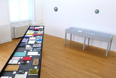Ausstellungsansicht ARTISTS' BOOKS I | mit Weltkugeltondi von Guido Nussbaum